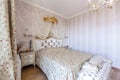 Elegant Royal white bedroom with a large double bed. White Carved back with a small canopy, white bedside tables with curved legs Royalty Free Stock Photo