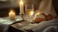 Elegant rustic table setting for communion with candles, bread, and wine in soft light Royalty Free Stock Photo