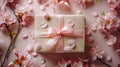 Elegant Sakura Gift Box with Pale Pink Satin Ribbon and Blooming Flowers on Soft Pink Background