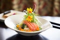 elegant sashimi arrangement with seaweed salad on the side