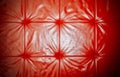 Elegant saturated glossy red leather texture of sofa chair