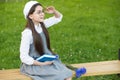 Elegant schoolgirl child girl reading book in park, elite school concept Royalty Free Stock Photo