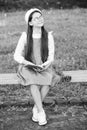 Elegant schoolgirl child girl reading book in park, learn grammar concept Royalty Free Stock Photo