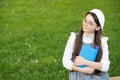 Elegant schoolgirl child girl reading book in park, poetry writer concept Royalty Free Stock Photo