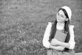 Elegant schoolgirl child girl reading book in park, poetry writer concept Royalty Free Stock Photo