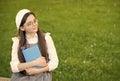 Elegant schoolgirl child girl reading book in park, poetry writer concept Royalty Free Stock Photo