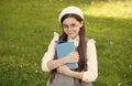 Elegant schoolgirl child girl study with book in park, learning concept Royalty Free Stock Photo