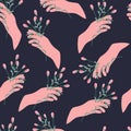 Elegant seamless pattern of hand holding blooming flowers on dark background. Floral vector illustration.