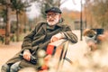 Elegant senior man sitting on bench in park Royalty Free Stock Photo