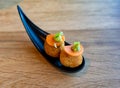 Elegant serving of two falafel balls with carrot and green leaves in modern restaurant