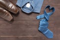 Elegant set: brown men`s shoes, blue shirt, blue necktie, on the Royalty Free Stock Photo