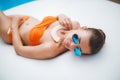 Beautiful young woman laying in bikini during sunbath next to swimming pool Royalty Free Stock Photo