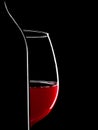 Elegant silhouette bottle of red wine and glass on black background Royalty Free Stock Photo