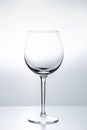 Elegant silhouette of an empty wine glass on a white background.