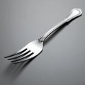Elegant Silver Fork on a Grey Background Royalty Free Stock Photo