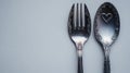 Elegant Silver Fork and Spoon with Small Heart Decorations Royalty Free Stock Photo