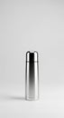 Sleek and Modern: A Minimalist Still Life of a Stainless Steel Thermos on a Clean, White Surface. Royalty Free Stock Photo