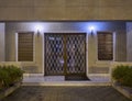 An elegant sixties apartment building`s main entrance framed glass door Royalty Free Stock Photo