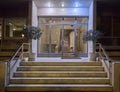 An elegant sixties apartment building`s main entrance, with marble stairs and a framed glass door Royalty Free Stock Photo
