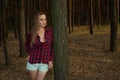 Elegant slender woman in forest among pines