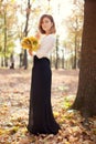 Elegant slim young girl in autumn park