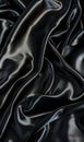 An elegant and smooth black silk fabric draped with soft shadows and highlights.