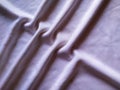Elegant soft foldings of silk fabric with tint of pink Royalty Free Stock Photo