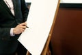 elegant speaker lecturer hands holding marker and writing at empty white board at business meeting , marketing lecture Royalty Free Stock Photo