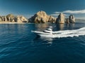 Elegant sportfishing yacht in the ocean in Cabo, Mexico sailing leisurely through a tranquil bay