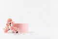 Elegant spring cylinder podium mockup with twig of pink sakura flowers, petals in white interior on table in japanese style