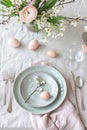 Elegant spring table setting with eggs and blooming flowers. . AI Generated Royalty Free Stock Photo