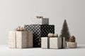 Elegant stack of assorted gift boxes with festive decorations and a miniature Christmas tree Royalty Free Stock Photo
