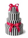 Elegant stack of black and white striped gift boxes with pink ribbons isolated on white background Royalty Free Stock Photo