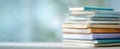 The elegant stack of books against a soft blue background. AI generated image Royalty Free Stock Photo