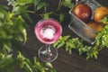 Elegant stemware glass of blood orange cocktail with big ice ball on dark wooden table surface, top view angle Royalty Free Stock Photo