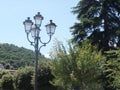 Elegant street lamp surrounded by trees in Laveno, north Italy