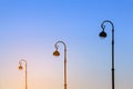 Elegant street lamps against the blue sky in the early morning in the light of the rising sun Royalty Free Stock Photo