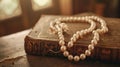 Elegant string of pearls draped over a vintage embossed leather book