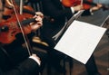 Elegant string quartet performing at wedding reception in restaurant, handsome man in suits playing violin and cello at theatre