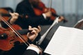 Elegant string quartet performing at wedding reception in restaurant, handsome man in suits playing violin and cello at theatre Royalty Free Stock Photo