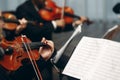 Elegant string quartet performing at wedding reception in restaurant, handsome man in suits playing violin and cello at theatre Royalty Free Stock Photo