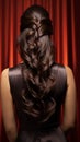Elegant studio pose Long, curly black hair adorns back of brunette woman