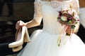 Elegant stylish bride in white vintage wedding dress shoes and b Royalty Free Stock Photo