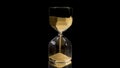 Elegant and stylish bronze transparent sandglass with trickling golden round particles. Stock footage. Sandglass