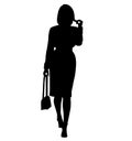 Elegant and stylish business woman very expressive goes to work on foot, from work. Dressed in knee length business dress