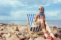 elegant stylish girl holding cocktail and relaxing in beach chair Royalty Free Stock Photo