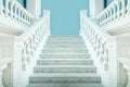 Elegant symmetric white staircase with a blue wall behind