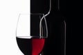 Elegant symmetry red wine glass and a wine bottle