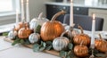 Elegant table centerpiece with pumpkins candles eucalyptus sprigs Royalty Free Stock Photo