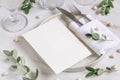 Elegant Table setting with a card decorated with eucalyptus branches close up, Wedding mockup Royalty Free Stock Photo